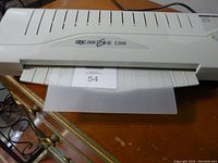 Front view of GBC DocuSeal 1200 with a lamination pouch inserted, showing brand and model.