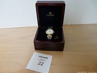 Men's Oskar Emil watch displayed inside a wooden case with black interior lining and logo, along with a Maxsold lot number card.