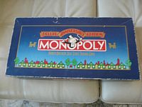 Top view of the Monopoly Deluxe Anniversary Edition blue box showing wear and scrapes on edges