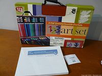 New 1-2-3 Art Set box showing colored pencils, paints, and brushes with a handle on top.