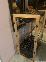 Wooden shoe rack with shoes and boots on shelves, showing front and side angles.
