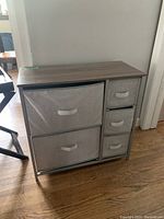 Small fabric dresser with grey fabric drawers and walnut wood top on metal frame