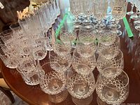 Top view of twelve crystal glasses showing cut diamond and crosshatch patterns.