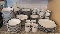 Full view of all items including stacks of plates, bowls, and cups in the dish set.