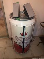 Stereo unit shaped like large Molson Canadian beer can, showing front branding, two bookshelf speakers on top and central stereo control unit.