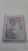 Front of the 1969 Topps Ernie Banks baseball card in a purple protective plastic sleeve.