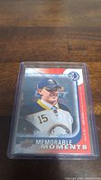 Clear image of the Jack Eichel hockey card in a protective plastic holder, featuring the player in Buffalo Sabres gear with Upper Deck Memorable Moments branding.