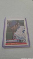 Front of a Joe Carter baseball card from 1984 Donruss Rated Rookie set in protective sleeve.