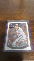 Kevin Gausman rookie baseball card showing him pitching in Orioles uniform inside protective plastic sleeve