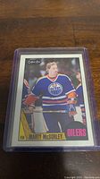 Photo shows a close-up of a Marty McSorley rookie hockey card in a protective sleeve. Card has O-Pee-Chee logo and depicts McSorley in Edmonton Oilers gear.