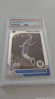 Front view of the 2018 NBA Hoops Premium Stock RJ Barrett Rookie Card #201 graded PSA 9 showing player in mid-air dunk in blue uniform.