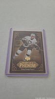 Sidney Crosby rookie hockey card titled Diary of a Phenom in clear purple protective sleeve.