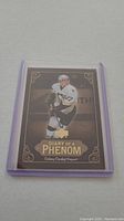 Front view of Sidney Crosby rookie hockey card in protective sleeve.