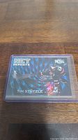 Holographic Tim Stutzle rookie hockey card from the Metal Universe series with Net Deposit design, inside protective sleeve.