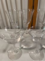 Set of crystal glasses with two taller glasses and two shorter glasses, clear and transparent with no damage.