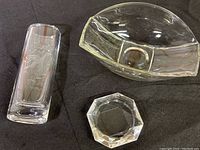 Three items displayed: tall crystal vase with bird engraving, glass bowl, and ashtray.