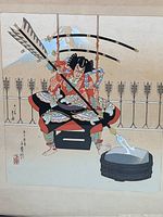 Close-up photo of the Japanese print showing the soldier sharpening weapons with arrows and bow in the background.
