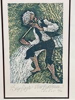 Full image of framed lithograph showing boy with flute standing on rocks by water.