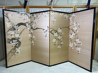 Overall front view of four-panel screen with cherry blossom painting on beige fabric and black wood frame