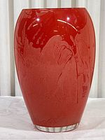 Front view of vintage watermelon colored glass vase showing mottled and textured glass finish with bright reddish-pink tone and rounded smooth shape tapering towards base.