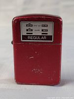 Front view of the lighter showing the gas pump themed display with the word 'REGULAR' and sales & gallons indicators.