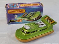 Matchbox Rescue Hovercraft toy with original colorful box in background showing graphics and branding.