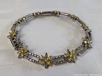 Full view of the 8-inch sterling silver bracelet showing rectangular and floral linked design with yellow citrine and marcasite stones.