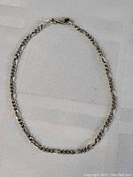 Sterling silver thick link chain laid flat showing full length and clasp