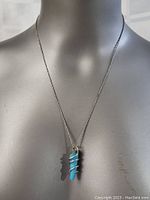 Full view of the necklace displayed on bust showing chain length and pendant placement.