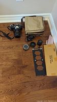 Overview of Nikon FE camera, lenses, filter, film guides and carrying case