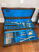 Full view of two-tier open wooden canteen showing all flatware laid out
