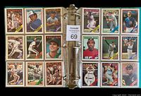 Two open binder pages showing 18 multi-team baseball cards including Yankees, Blue Jays, Brewers, Dodgers, Mariners, Cubs, Astros, Expos, Tigers, Orioles, Red Sox, Royals, Padres, Giants with color team headers and player names.