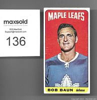 Front of the 1964-65 Topps Tall Boy hockey card showing Bob Baun in Maple Leafs uniform with red background.