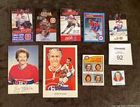 Top view of Montreal Canadiens collectibles including schedules, postcards, and hockey cards arranged on surface