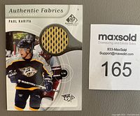 Close-up of Paul Kariya SPX Authentic Fabrics hockey card showing single jersey swatch and player image.