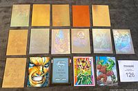 Front sides of 16 superhero cards including holograms and inserts showing character artwork for X-Men, Superman, Hulk, and others