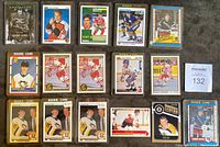 Close-up image of 15 individual hockey cards including Rookie cards and star players laid flat on dark surface showing various player names, teams, and card designs from the 1990s