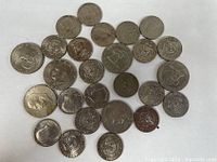 27 assorted US collectible coins including one dollar and half dollar denominations, showing obverse and reverse sides of multiple coins with various designs and profiles.