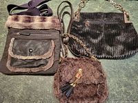 Three faux-furry handbags laid out showing detail of size and textures