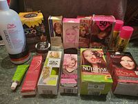 Photo showing all hair colouring products in lot, includes boxes and bottles from multiple brands.