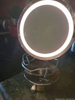 Front view of the round lighted magnifying mirror with illuminated LED light ring.