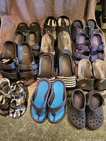 All 12 pairs of boys' summer footwear arranged together showing different styles, colors, and sizes.