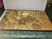 Table runner in box showing floral design and shiny fabric