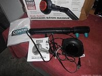 Overall view showing the handheld Conair massager, power cord, two attachments, instruction manual, and original box.