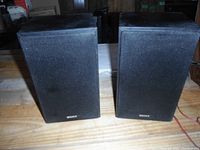 Pair of Sony bookshelf speakers shown side by side front view with black fabric grills covering drivers.