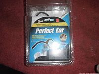 Front view of original packaging showing product name Perfect Ear Personal Sound Amplifier, primarily blue background with product image and information.