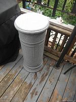 Image showing a gray speckled round column plant stand, 32 inches high and 13 inches wide, with decorative moldings and minor wear including chips and scratches.