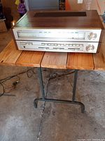 Full front and top view of Toshiba SA-520 stereo receiver on wooden table in garage.