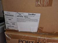 Photo of the box label showing product details including brand SanMar, color white, style VNMASK02, and quantity 500 masks.