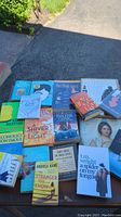 Photo showing a selection of paperback and hardcover books including Alcoholics Anonymous and Shiver of Light.